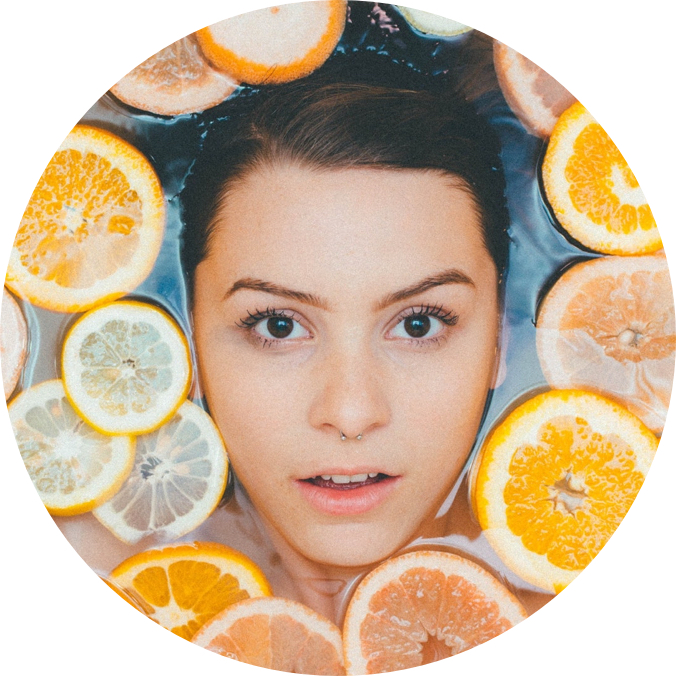 Cook's face getting out of the water surrounded by oranges and lemon.